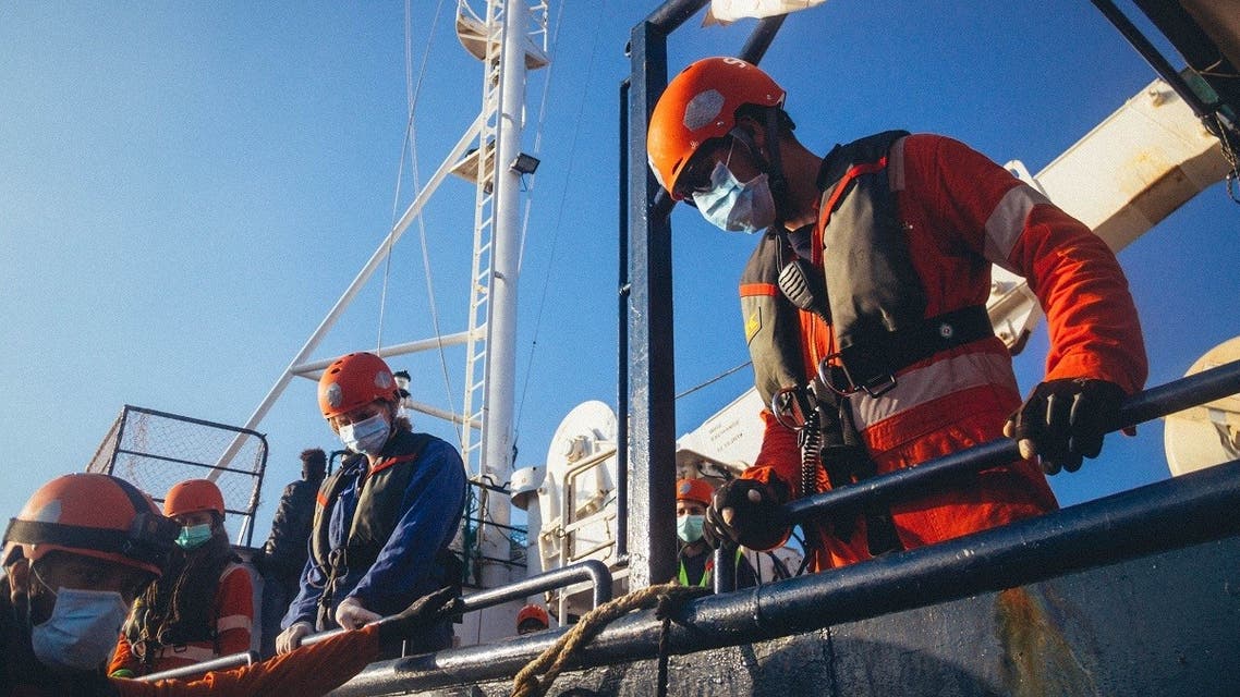 A handout picture released by German migrant rescue NGO Sea-Eye and taken on April 6, 2020, shows members of the NGO on board their vessel Alan Kurdi during a rescue operation off the Libyan coast. (AFP/Cedric Fettouche/sea-eye.org)