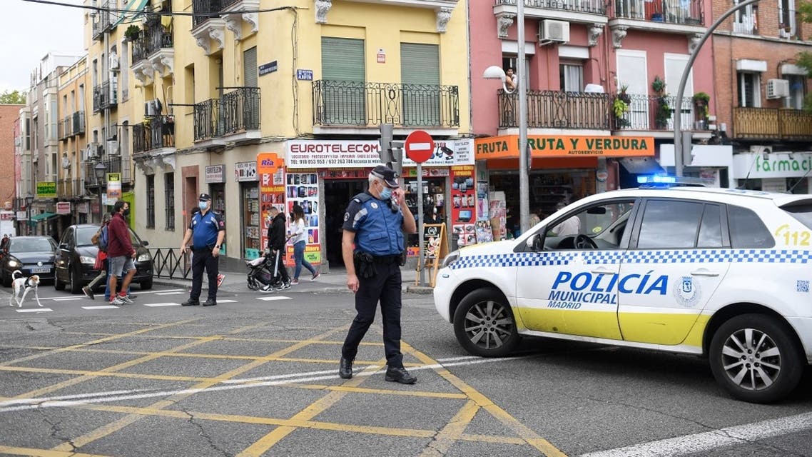 Policemen block a street at the Vallecas neighborhood in Madrid, on September 20, 2020, during a demonstration against the new restrictive measures announced by regional authorities. (AFP)