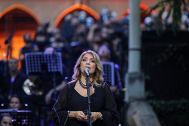 Lebanese singer Fadia Tomb El-Hage performs with a choir at a concert for the victims of August's deadly Beirut blast, in the gardens of the damaged 19th-century Sursock Palace in Achrafieh in Lebanon's capital, on September 20, 2020. (AFP)