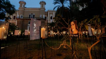 Candles light-up pictures of victims of August's deadly Beirut blast during a commemoration concert in the gardens of the damaged 19th-century Sursock Palace in Achrafieh. (AFP)