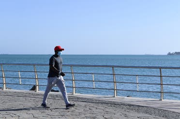 A man walks at the seafront promenade in the Saudi seaport of jeddah, on June 21, 2020, as the country re-opens following the lifting of a lockdown due to the COVID-19 pandemic. (AFP)