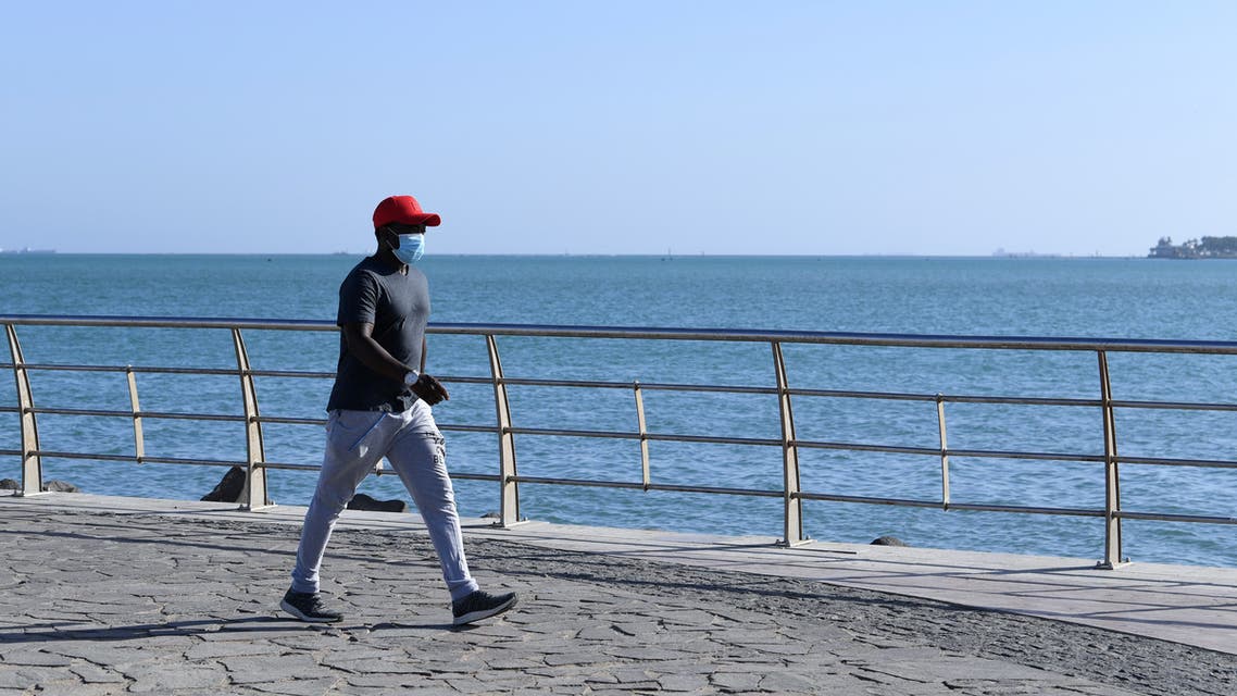 A man walks at the seafront promenade in the Saudi seaport of jeddah, on June 21, 2020, as the country re-opens following the lifting of a lockdown due to the COVID-19 pandemic. (AFP)