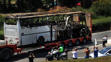 A truck carries the bus damaged by the suicide bomb blast which targeted a group of Israeli tourists at the airport in Bourgas, Bulgaria, on July 19, 2012. (AFP)