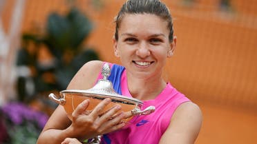 Romania’s Simona Halep  the trophy after Czech Republic’s Karolina Pliskova retired from the match at the Italian Open in Rome, on September 21, 2020. (Reuters)