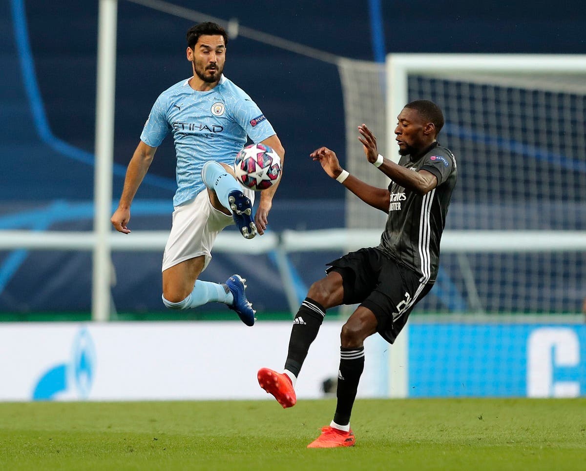 Manchester City's Ilkay Gundogan kicks the ball clear during the Champions League quarterfinal soccer match between Lyon and Manchester City at the Jose Alvalade stadium in Lisbon, Portugal, Saturday, August 15, 2020. (AP)