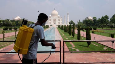 A man sanitizes railings in the premises of Taj Mahal after authorities reopened the monument to visitors, amidst the coronavirus disease (COVID-19) outbreak, in Agra, India. (Reuters)