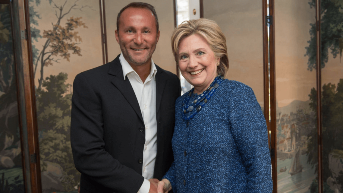 Allid Wallet CEO Andy Khawaja meets with Hilary Clinton, in Los Angeles, in 2016. (Allied Wallet website)