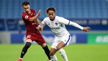 Al-Hilal's midfielder Andre Carrillo (R) is marked by Shahr Khdro's midfielder Rouhollah Seifollahi (L) during the AFC Champions League group B match. (AFP)