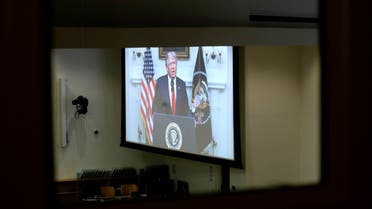 President Trump is seen on a screen through a window to an empty conference room as he delivers a pre-recorded address to the 75th annual UN General Assembly. (Reuters) 