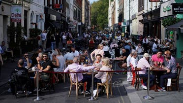 People sit at the tables outside restaurants in Soho, amid the coronavirus disease (COVID-19) outbreak, in London, Britain. (Reuters)
