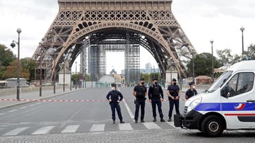 French police stand near the Eiffel Tower after the French tourism landmark was evacuated following a bomb alert in Paris, France, September 23, 2020. (Reuters)