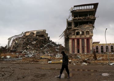 A student walks past badly damaged buildings at the University of Mosul, that was retaken by Iraqi security forces from Islamic State militants, on the eastern side of Mosul, Iraq, Sunday, Jan. 22, 2017. (AP)