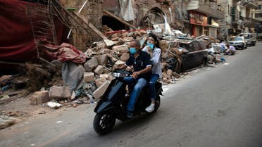 People on a scooter drive by damaged traditional Lebanese house, following a massive explosion at the port area, in Beirut. (Reuters)