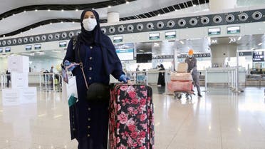 A passenger wearing a protective face mask walks at Riyadh International Airport. (File photo: Reuters)