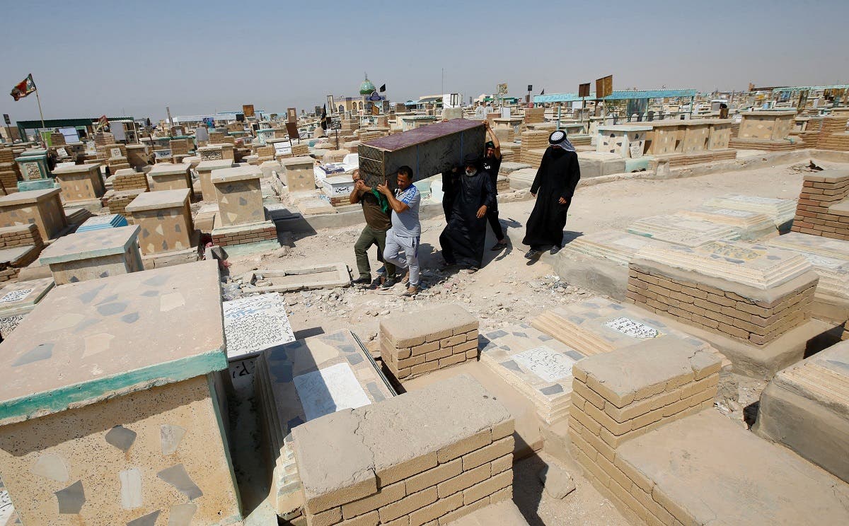 Iraqi men carry the coffin of a relative who, according to them, died of the coronavirus disease (COVID-19), after being taken from a cemetery dedicated to those who died of COVID-19, as they arrive to rebury him at the Valley of Peace cemetery located in the holy city of Najaf, Iraq. (Reuters)