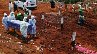 Workers wearing protective suits carry a coffin at the Muslim burial area provided by the government for victims of the coronavirus disease (COVID-19) at Pondok Ranggon cemetery complex in Jakarta, Indonesia. (Reuters)