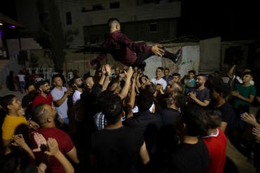 A Palestinian groom is thrown in the air during a wedding party in Azmut near the West Bank city of Nablus, Sept. 24, 2020. (AP)