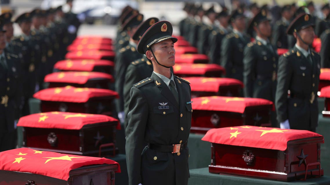 In this photo provided by China's Xinhua News Agency, caskets containing the remains of Chinese soldiers killed in the Korean War are escorted by honor guards at the Taoxian international airport in Shenyang, northeast China's Liaoning Province, Sunday, Sept. 27, 2020. (AP)
