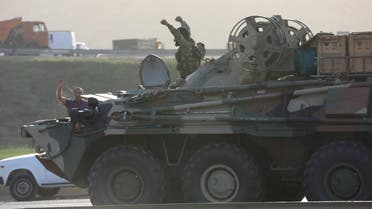 An Azerbaijani service member drives an armoured carrier in Baku. (Reuters)