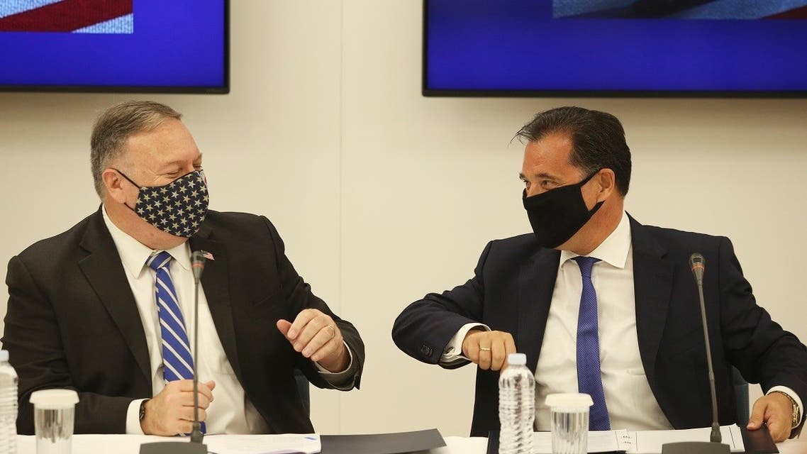 US Secretary of State Mike Pompeo (left) and Greek Minister for Development and Investment Adonis Georgiadis touch elbows during a signing agreement ceremony in the northern city of Thessaloniki, Greece, on September 28, 2020. (AP)