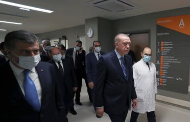 Turkey’s President Recep Tayyip Erdogan, front center, arrives to attend the inauguration ceremony for Basaksehir Pine and Sakura City Hospital, in Istanbul, Thursday, May 21, 2020. (Turkish Presidency via AP)