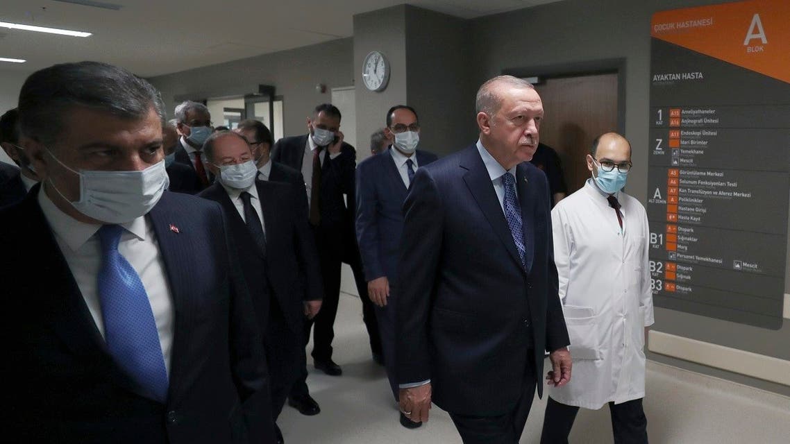 Turkey’s President Recep Tayyip Erdogan, front center, arrives to attend the inauguration ceremony for Basaksehir Pine and Sakura City Hospital, in Istanbul, Thursday, May 21, 2020. (Turkish Presidency via AP)