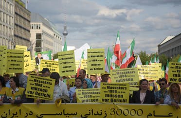 Activists hold banners during a demonstration against executions in Iran, in Berlin, Germany September 3, 2016. The banners in German read 'The people who are responsible for the 1988 massacres in Iran need to be brought to court.'  (Reuters)