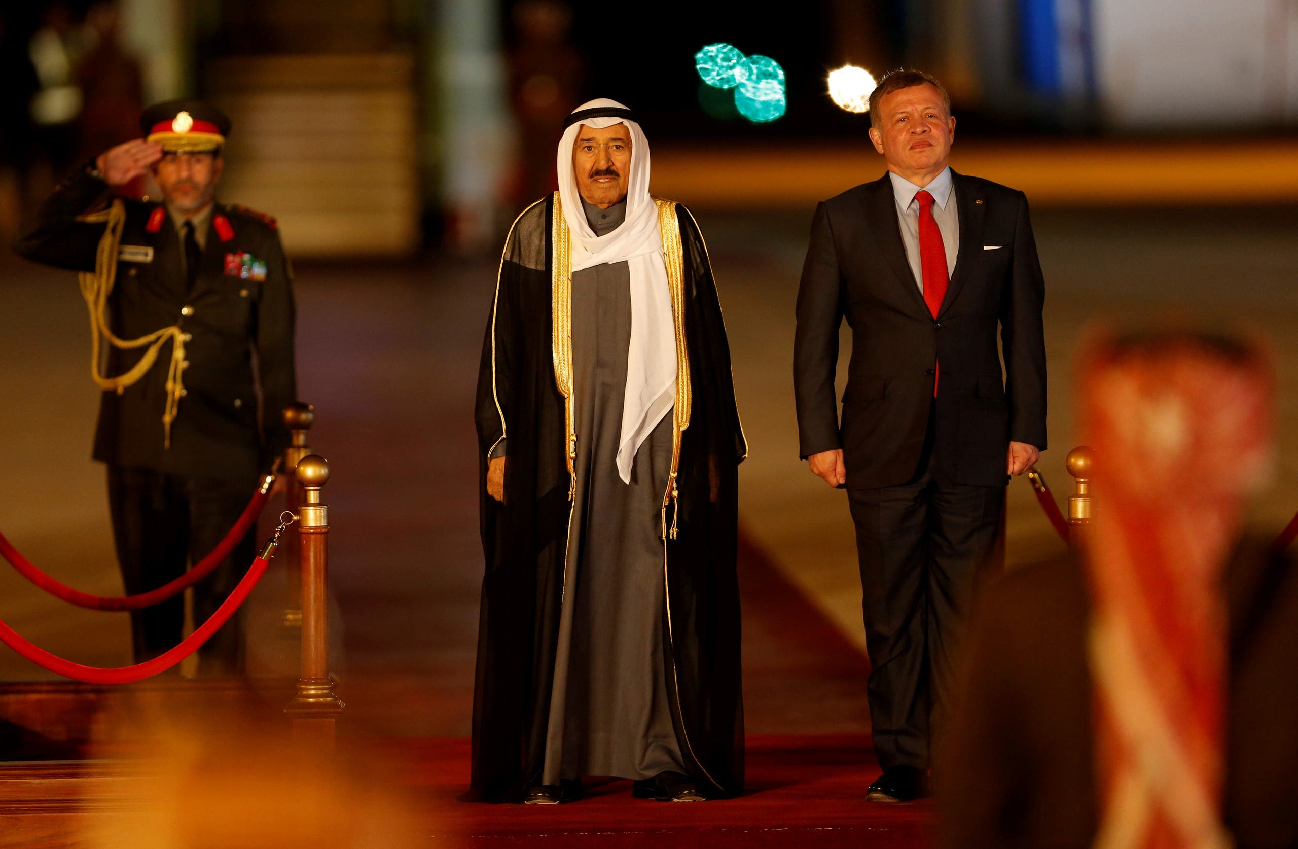 Jordan's King Abdullah II stands next to Emir of Kuwait Sabah Al-Ahmad Al-Jaber Al-Sabah during a reception ceremony at the Queen Alia International Airport in Amman. (Reuters)