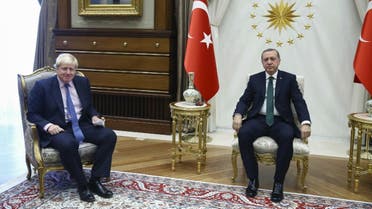 This handout picture by the Turkish Prime Ministry Press Service shows Turkey's President Recep Tayyip Erdogan (R) and British Foreign Minister Boris Johnson posing prior to a meeting in Ankara. (AFP)