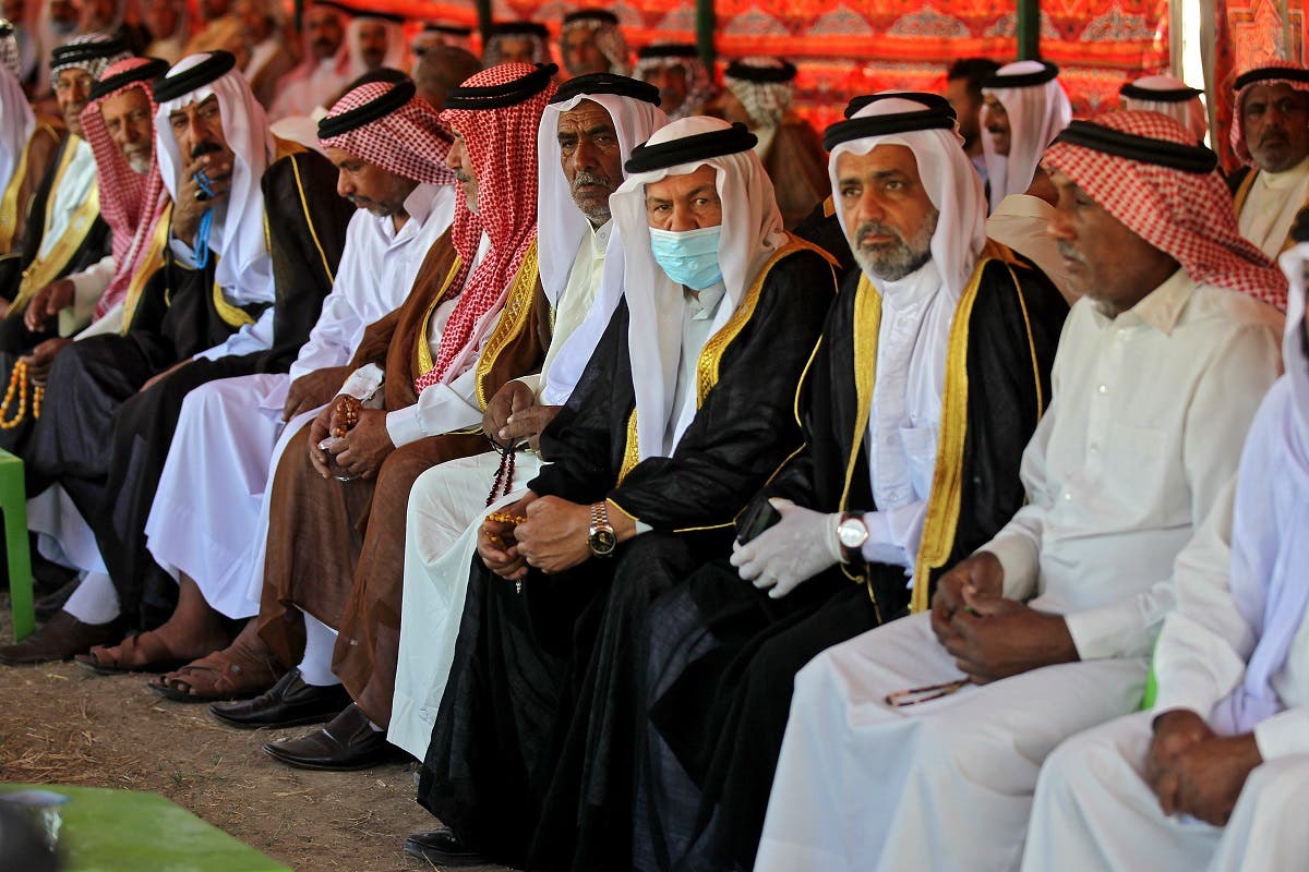 Iraqi tribal dignitaries attend the funeral of a family killed a day earlier when a rocket hit their home near Baghdad's airport, in the village of Al-Bu Shaban in the Radwaniyah area on the outskirts of the capital, on September 29, 2020. (AFP)
