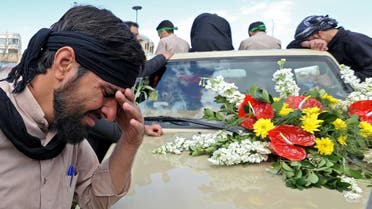 An Iranian man cries during the funeral of members of Revolutionary Guards, who were killed in a suicide attack, in the central Iranian city of Isfahan on February 16, 2019. (AFP)