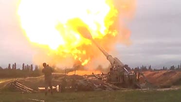 A still from Azerbaijan's Defense Ministry’s video shows members of Azeri armed forces firing artillery during clashes between Armenia and Azerbaijan over Nagorno-Karabakh in an unidentified location, from footage released September 28, 2020. (Reuters)