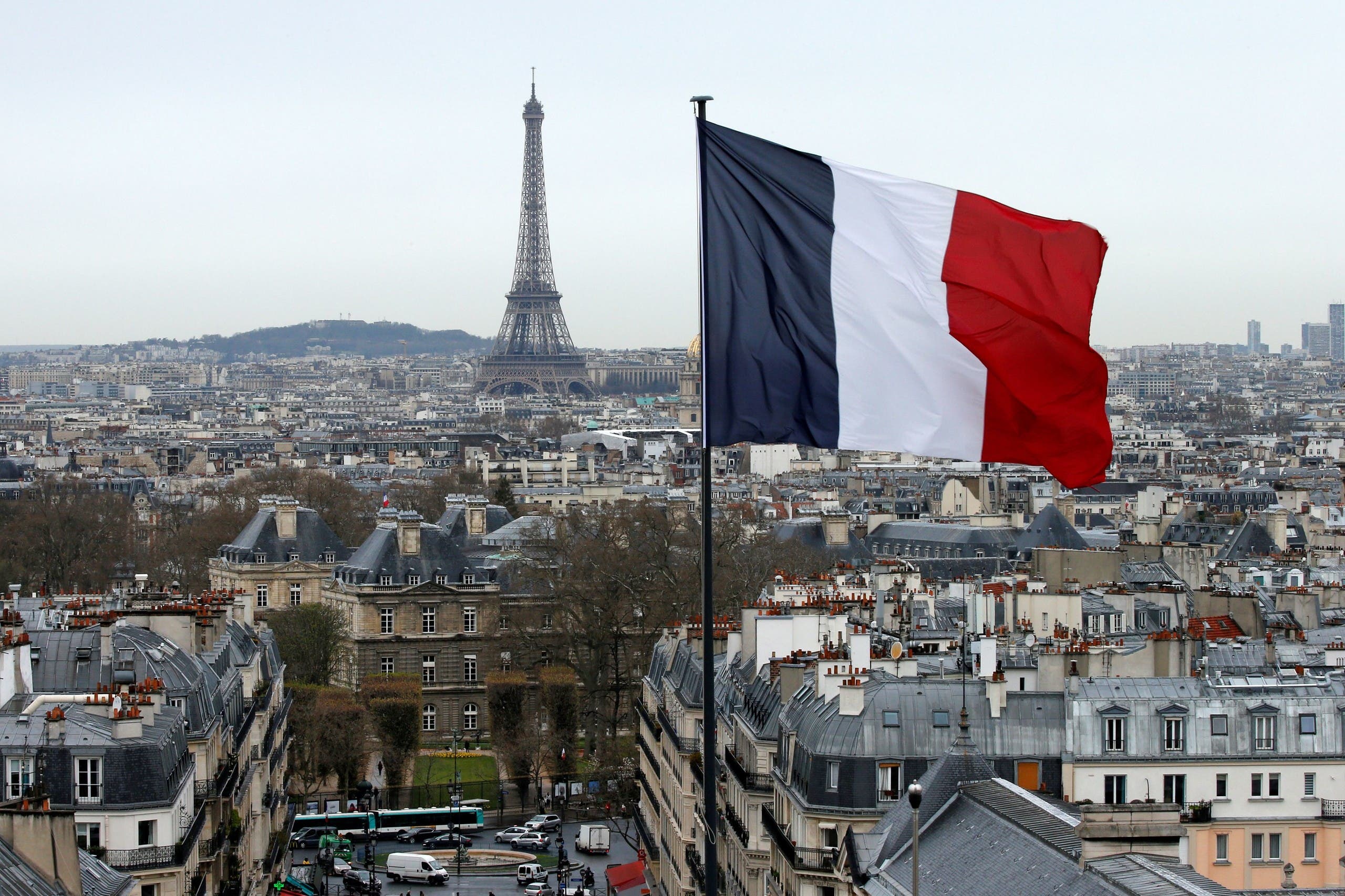 A French flag waves above the skyline as the Eiffel Tower and roof tops are seen in Paris, France. (Reuters)