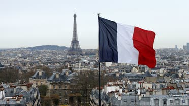 A French flag waves above the skyline as the Eiffel Tower and roof tops are seen in Paris, France. (Reuters)