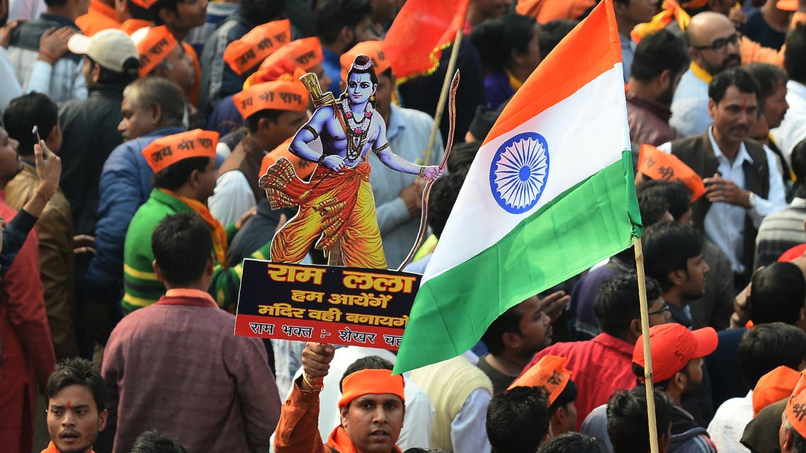 An Indian Hindu hardliner holds a cutout of Hindu God Ram as he participates in a rally calling for the construction of a temple on the site of the demolished 16th century Babri mosque - AFP
