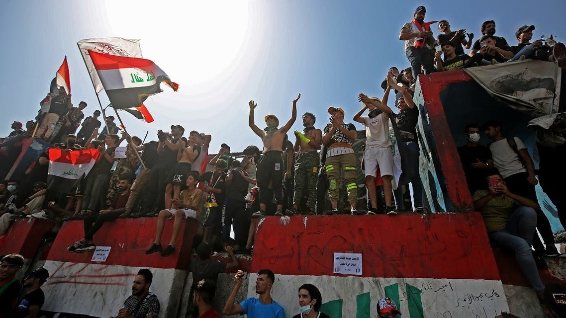 Iraqi protesters chant slogans and wave the national flag during a demonstration in Tahrir Square in the center of Iraq's capital Baghdad on Oct. 1, 2020. (AFP)