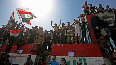 Iraqi protesters chant slogans and wave the national flag during a demonstration in Tahrir Square in the center of Iraq's capital Baghdad on Oct. 1, 2020. (AFP)