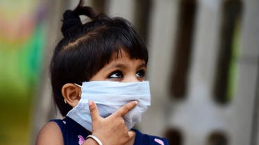 A child waits to get tested for the COVID-19 coronavirus outside a testing facility in Allahabad on August 7, 2020. (AFP)