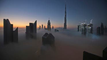 FILE - In this Dec. 31, 2016 file photo, the sun rises over the city skyline with the Burj Khalifa, the world's tallest building, on a foggy day in Dubai, United Arab Emirates. (AP)