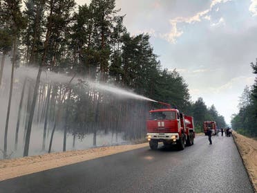 Firefighters work to put out a forest fire in Luhansk Region, Ukraine July 7, 2020. (Reuters)
