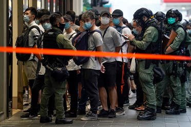 Police detain people inside a cordoned area during China’s National Day in Causeway Bay, Hong Kong, on October 1, 2020. (AP)