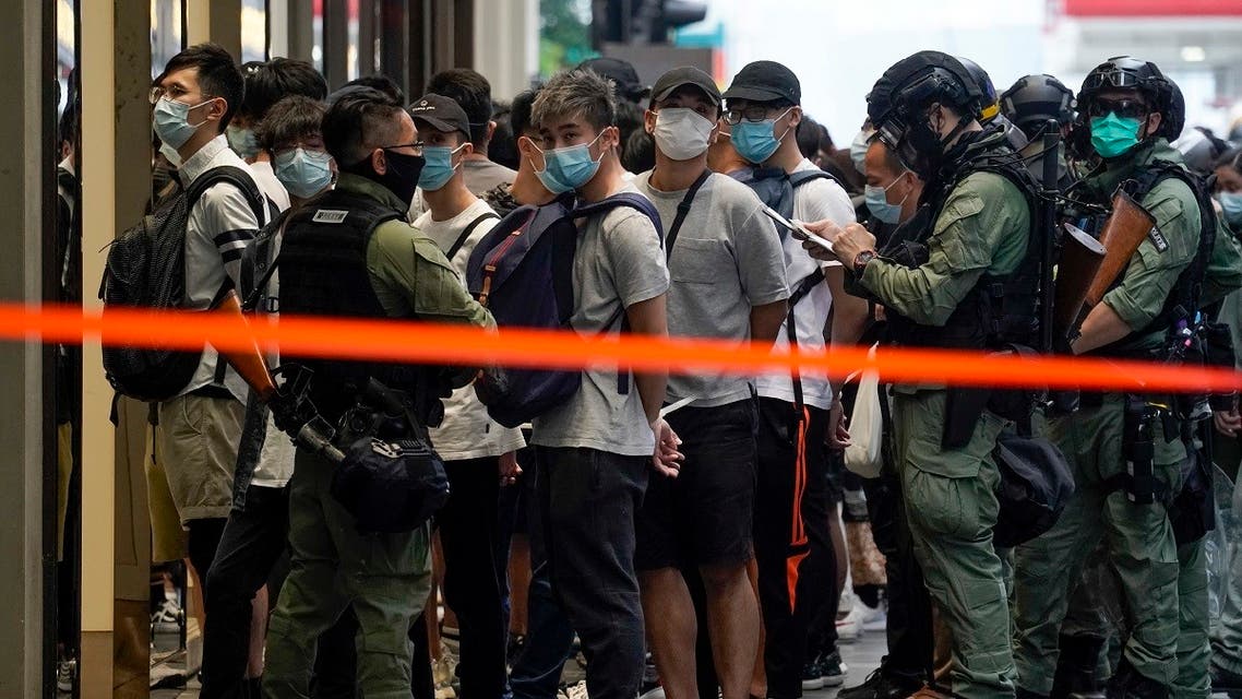 Police detain people inside a cordoned area during China’s National Day in Causeway Bay, Hong Kong, on October 1, 2020. (AP)