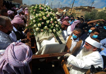 Iraqi Yazidi men surround the casket of Baba Sheikh Khurto Hajji Ismail, supreme spiritual leader of the Yazidi religious minority, during his funeral procession. (AFP)