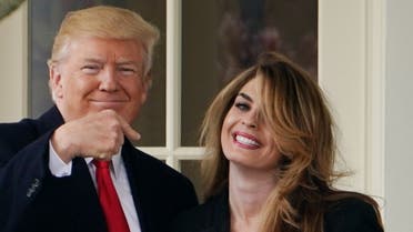 US President Donald Trump points to former communications director Hope Hicks shortly before making his way to board Marine One on the South Lawn and departing from the White House on March 29, 2018. (AFP)