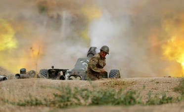 A serviceman of Karabakh's Defence Army fires an artillery piece towards Azeri positions during fighting over the breakaway Nagorny Karabakh region on September 28, 2020. (AFP)