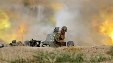 A serviceman of Karabakh's Defence Army fires an artillery piece towards Azeri positions during fighting over the breakaway Nagorny Karabakh region on September 28, 2020. (AFP)