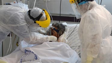 A patient infected by coronavirus receives treatment at the intensive care unit of a hospital in the southwestern Tunisian town of Gabes, August 26, 2020. (AFP)