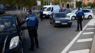 Local police officers control people's movement in a traffic checkpoint in Madrid, on October 3, 2020. (AFP)