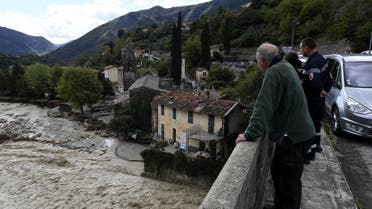 Bystanders gather on a bridge as they look at the River Vesubie in Roquebilliere, south-eastern France, on October 3, 2020. (AFP)