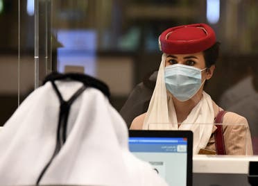 A stewardess of an Emirates Airlines flight from London arrives at Dubai International Airport on May 8, 2020 amid the coronavirus Covid-19 pandemic. (AFP)